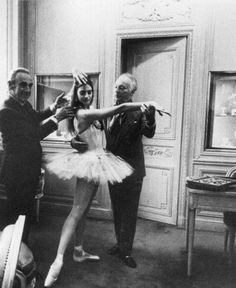 an old black and white photo of two people dressed as ballerinas with their arms outstretched