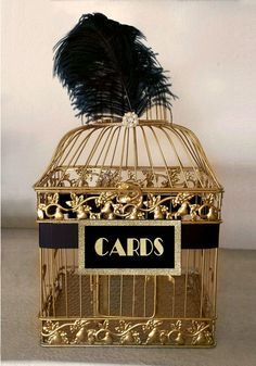 a golden birdcage with a black label on it