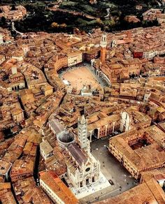 an aerial view of a large city with lots of tall buildings and brown brick roofs