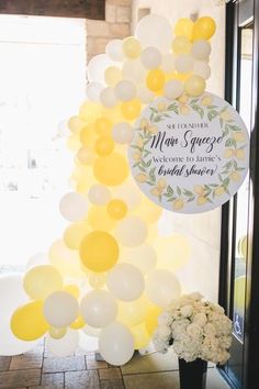 balloons and flowers are on display in front of a door