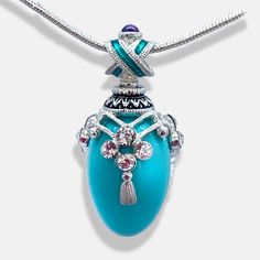 Turquoise is considered a healing and protective stone that enhances courage in the wearer and is also said to attract love, friendship, money, and luck. ... This high-quality, magnificent handmade pendant was inspired by and designed in a Faberge style. The 18mm x 12mm egg-shaped turquoise is set in a 925 sterling silver design of three equal wire arch segments. They are decorated with four 2.3mm Premium crystals and tassels on the bottom of each arch. The "X" shaped bail is enameled with a tur Spiritual Turquoise Necklace Collectible, Spiritual Healing Teardrop Pendant Jewelry, Spiritual Keepsake Pendant Jewelry, Spiritual Gemstone Jewelry For Keepsake, Bohemian Adjustable Jewelry For Keepsake, Adjustable Bohemian Jewelry Keepsake, Spiritual Teardrop Pendant Jewelry With Large Stone, Spiritual Oval Pendant Keepsake Jewelry, Spiritual Birthstone Jewelry Collectible