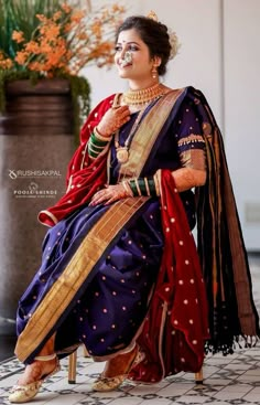 a woman in a blue and red sari