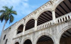 an old building with arches and palm trees