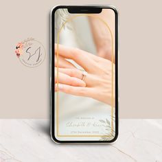 an iphone case with a wedding photo on it and a gold ring in the middle