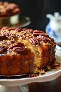 a bundt cake with pecans and caramel drizzled on top