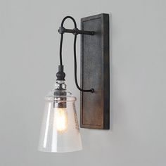 a wall light with a glass shade on it