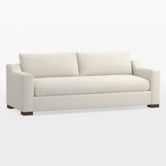 a beige couch sitting on top of a white floor