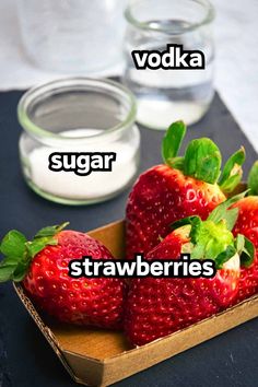 three strawberries in a box with the words vodka, sugar and strawberry on top