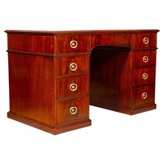 an antique wooden desk with two drawers and gold pulls on the top, against a white background