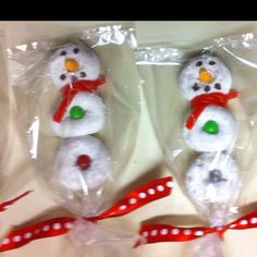 two snowmen are wrapped in plastic and sitting next to each other