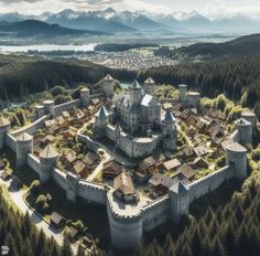 an aerial view of a castle in the middle of trees with mountains in the background