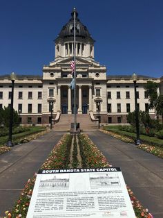 the state capitol building with flowers in front