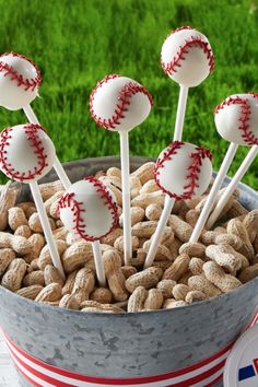 a bucket full of peanuts with baseballs on them