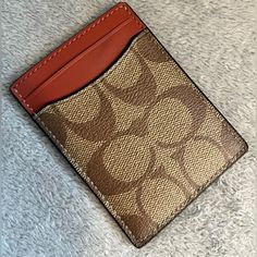 This Coach Mini Wallet In A Tan And Orange Signature Pattern Is Perfect For The Stylish Woman On-The-Go. With Ample Space For Cards And A Bill Compartment, This Wallet Is Both Functional And Fashionable. Made For Women, It Is A Must-Have Accessory To Complete Any Outfit. The Wallet Is In Excellent Shape And Has Never Been Worn. New Without Tag Classic Brown Coach Card Holder, Coach Brown Wallet With Card Slots, Coach Rectangular Card Holder With Coin Pocket, Casual Coach Wallets For Daily Use, Casual Coach Wallet For Daily Use, Designer Gold Card Holder For Everyday Use, Tan Wallets With Card Slots For Everyday Use, Designer Brown Coach Wallet, Casual Coach Wallets For Everyday Use