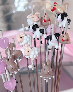 a bunch of cake toppers that are on sticks