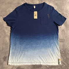 This Is A Nwt Men’s G-Star Raw Galley Indigo Dipped T-Shirt. It’s A Size Xl And It’s In Brand New Unused Condition. Features: Crew Neckline. Short Sleeve. Subtle G-Star Raw Logo On Left Front And On Left Sleeve. G-Star Raw Tag On Left Bottom Side Seam. Pocket On Left Side Of Chest. Relaxed And Masculine Silhouette. Measures 23 Inches From Armpit To Armpit. Casual Ombre Cotton Tops, Casual Ombre Tops For Summer, Casual Bleached Blue Top, Casual Blue Bleached Top, G Star Raw, Crew Neckline, Tee Shirts, Mens Shirts, Man Shop