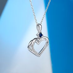 This captivating double heart necklace symbolizes love, connection, and unity. This exquisite piece features two hearts, with one heart delicately layered upon the other, creating a beautiful and harmonious design that represents the inseparable bond between two souls. At the center of the necklace rests a stunning blue stone, adding a touch of elegance and sophistication to the piece. The blue stone symbolizes trust, loyalty, and inner peace, infusing the necklace with a sense of calm and seren Sterling Silver Necklace With Heart Charm For Promise, Promise Necklace With Heart Pendant, Promise Necklace With Heart Charm And Shape, Sterling Silver Promise Necklace For Mother's Day, Double Heart Charm Necklace For Promise, Promise Necklace With Heart Charm, Promise Necklaces With Heart Charm, Elegant Necklaces For Mother's Day Promise, Elegant Necklace For Mother's Day Promise