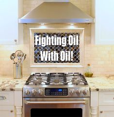 a stainless steel stove top oven sitting in a kitchen next to white cabinets and counter tops