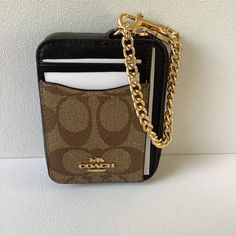 COACH Zip Credit Card & I.D. Case BNWT Style C1885 Khaki Brown Signature Coated Canvas & Black Leather  2 outside Card Slots + Clear Window I.D. Pocket Gold Plated Hardware Gold Chain with Trigger Swivel Clasp, great to attach to Belt Loop, Handbag, Bookbag Black interior lined Measures 4”x3.5” All items from a smoke & pet free environment Coach Wallet On Chain, Coach Wallet On Chain With Details, Coach Black Card Holder With Card Slots, Coach Brown Wallets For On-the-go, Black Coach Bag With Gold-tone Hardware, Clear Windows, Black Interior, Card Case, Gold Chains