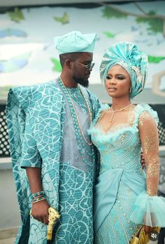 a man and woman dressed in blue posing for the camera