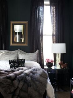 a black and white bedroom with fur on the bed