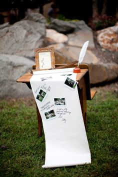 a white sheet of paper sitting on top of a wooden table next to an easel