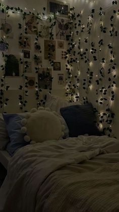 a bedroom decorated with lights and pictures on the wall