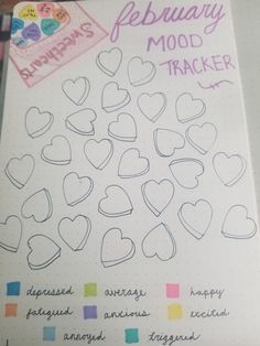 a notebook with hearts drawn on it and the words february mood trackerr written in cursive writing