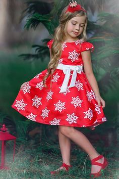 This holiday dress looks like a wrapped present and is perfect for holiday celebrations. The satin fabric and the cute bow at the waist will make everyone swoon over your happy little one. This beautiful winter gown was made for visits with Santa and exchanging gifts. Snowflake Dress, Red Snowflake, Polka Dot Blazer, Snow Flakes, Girls Red, Christmas Parties, Holiday Dress, Holiday Looks, Sweet Dress