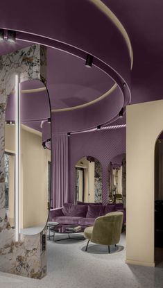 a living room with purple and beige furniture in it's centerpiece, along with marble walls