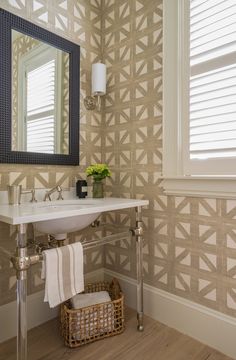 a white sink sitting under a bathroom mirror