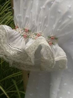 white dress with pink flowers and lace on it