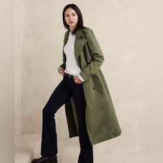 A Classic Water-Resistant Trench Coat In A Modern Oversized Fit. Crafted To Offer A Chic And Refined Look, Allowing For A Relaxed And Effortlessly Elegant Fit. Removable Fabric Belt Included. Notch Collar. Long Sleeves With Button Tab Cuffs. Double Breasted Button Closure. Shoulder Epaulettes. Boxy Shoulder Pads. Front And Back Storm Flaps. Vertical On-Seam Front Pockets. Center Back Vent. Fully Lined. Green Trench Coat Outfit, Airplane Outfit, Petite Trench Coat, Corporate Girl, Long Coat Outfit, Oversized Trench, Shoulder Epaulettes, Duck Jacket, Green Trench Coat