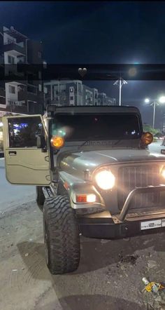 two jeeps are parked next to each other in the parking lot at night time