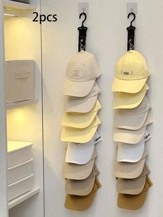 there are two hats hanging on the wall