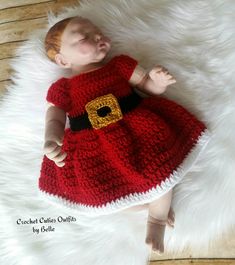 a baby doll is dressed in a red crochet dress and has a santa clause belt