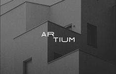 the word artum is written in front of an image of a building with windows