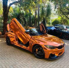 an orange sports car with its doors open