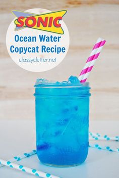 a blue drink in a mason jar with straws