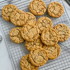 a bunch of cookies that are on a cooling rack