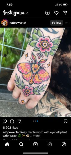 a person's foot with flowers on it and a butterfly tattooed on the toe