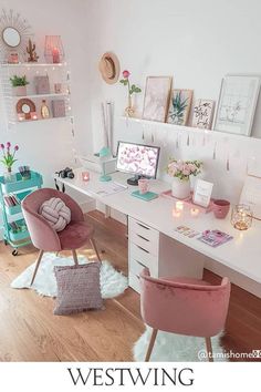 a white desk with pink chairs and pictures on the wall