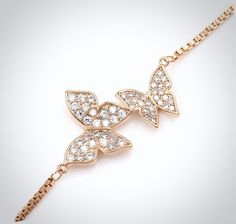 Butterflies represent a passionate bond and endless love. Perfect for a butterfly-themed wedding, this delicate bracelet is an ideal accessory for the minimalist bride, or can make a thoughtful gift for your young bridesmaids or flower girls. Adorned with flawlessly faceted cubic zirconia, it captures the light from every angle with a perfectly translucent appeal, sparkling beautifully. All it takes is a simple glance at this beautiful design to see its extremely subtle and classy look that make Elegant Butterfly Charm Jewelry For Wedding, Adjustable Rose Gold Jewelry With Butterfly Charm, Rose Gold Adjustable Jewelry With Butterfly Charm, Elegant Butterfly-shaped Wedding Jewelry, Dainty Butterfly Charm Jewelry For Wedding, Elegant Silver Bracelet With Butterfly Clasp, Wedding Jewelry With Butterfly Charm In Cubic Zirconia, Elegant Adjustable Bracelets With Butterfly Charm, Wedding Jewelry With Cubic Zirconia Butterfly Charm