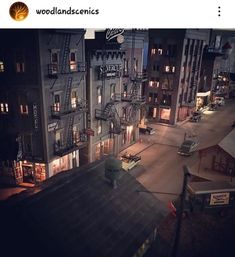 an aerial view of a city at night with buildings and fire escape ladders lit up