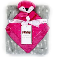 a pink teddy bear wrapped in a blanket with a tag on it's chest