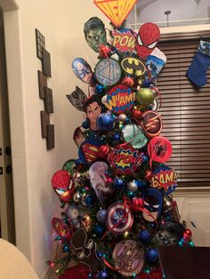 a christmas tree decorated with comic themed ornaments