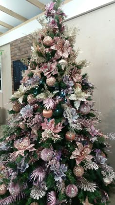 a christmas tree decorated with pink and purple ornaments