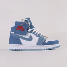 Debuted in 1985, the Air Jordan 1 Denim High Top offers a rendition to the iconic classic. Released September 22nd, 2022.* Gold bamboo hoop earrings on laces * White leather upper with stone wash denim overlays * White patched wings logo on the side * Denim and white colourway Size and Fit* Fits true to size Air Jordan 1 Denim, Jordan 1 Denim, High Top Air Jordans, Jordan Aesthetic, Jordans Aesthetic, Shoe Custom, Pretty Sneakers, Nike High Tops, Bamboo Hoop Earrings