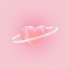 a pink heart shaped object in the middle of a ring on a pink background with space for text