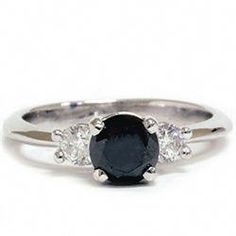 a black diamond ring with three diamonds on it